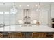 Close-up of the kitchen island featuring a stainless steel sink and wicker chairs for seating at 2951 Clearwater Dr, Mount Pleasant, SC 29466