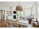 Open-concept dining and living room with a statement pendant light and ample natural light at 2951 Clearwater Dr, Mount Pleasant, SC 29466