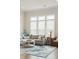 Bright and airy living room with a comfortable gray sofa and a blue patterned rug at 2951 Clearwater Dr, Mount Pleasant, SC 29466