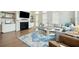 Bright living room features a decorative fireplace, a comfortable sofa, and a blue area rug at 2951 Clearwater Dr, Mount Pleasant, SC 29466