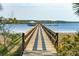 Long wooden pier extending into the tranquil lake, offering a serene spot for fishing and enjoying waterfront views at 2951 Clearwater Dr, Mount Pleasant, SC 29466