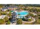 An aerial view showing a resort-style pool with a water slide and tower, surrounded by landscaping and palm trees at 2951 Clearwater Dr, Mount Pleasant, SC 29466