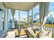 Inviting screened-in porch with comfortable seating, curtains, and views of the surrounding neighborhood at 2951 Clearwater Dr, Mount Pleasant, SC 29466