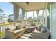 Cozy screened-in porch with wicker furniture, cushions, and an outdoor ceiling fan at 2951 Clearwater Dr, Mount Pleasant, SC 29466
