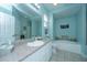 Spacious bathroom featuring a double sink vanity, soaking tub, toilet, and large mirror for added convenience at 2952 Sweetleaf Ln, Johns Island, SC 29455