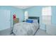 Comfortable bedroom with blue walls, natural light, and a cozy bed, creating a relaxing atmosphere at 2952 Sweetleaf Ln, Johns Island, SC 29455