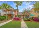 Inviting two-story home with lush landscaping, vibrant flowers, and a charming walkway leading to the front door at 2952 Sweetleaf Ln, Johns Island, SC 29455
