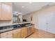 Clean kitchen with stainless steel appliances, a double sink, wood cabinets, and an adjacent dining area at 2952 Sweetleaf Ln, Johns Island, SC 29455