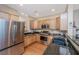 Well-appointed kitchen with stainless steel appliances, dark granite countertops, and natural wood cabinets at 2952 Sweetleaf Ln, Johns Island, SC 29455