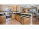 Functional kitchen with stainless steel appliances, granite counters, wood cabinetry, and an open layout to the living area at 2952 Sweetleaf Ln, Johns Island, SC 29455