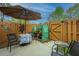 Cozy backyard patio setup with seating, umbrella, and greenhouse for a relaxing outdoor space at 2952 Sweetleaf Ln, Johns Island, SC 29455