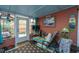 Inviting sunroom with comfortable seating, bright windows and door to the backyard at 2952 Sweetleaf Ln, Johns Island, SC 29455