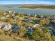 Aerial view of a home in a waterfront community with mature trees and scenic water views at 3075 Maritime Forest Dr, Johns Island, SC 29455