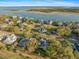 Aerial view of a home in a waterfront community with mature trees and scenic water views at 3075 Maritime Forest Dr, Johns Island, SC 29455