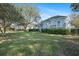 Beautiful backyard showcasing a well-maintained lawn, mature trees, and a charming home exterior at 3075 Maritime Forest Dr, Johns Island, SC 29455