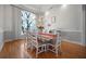 Dining room features hardwood floors, a large window, paneled walls, and modern lighting at 3075 Maritime Forest Dr, Johns Island, SC 29455
