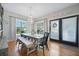 Bright dining room features a large dining table, windows, and French doors leading outside at 3075 Maritime Forest Dr, Johns Island, SC 29455