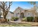 Charming home with a stucco facade, manicured landscaping, and an American flag at 3075 Maritime Forest Dr, Johns Island, SC 29455