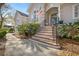 Inviting front entrance with brick stairs, wrought iron railings, and lush landscaping at 3075 Maritime Forest Dr, Johns Island, SC 29455