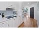 Bright kitchen with white cabinets, countertops, and modern appliances and a hardwood floor at 3075 Maritime Forest Dr, Johns Island, SC 29455