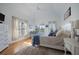 Light-filled main bedroom boasts a plush rug, large bed, and access to outdoor balcony at 3075 Maritime Forest Dr, Johns Island, SC 29455