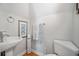 Charming powder room with a pedestal sink, decorative accents, and wood-look flooring at 3075 Maritime Forest Dr, Johns Island, SC 29455