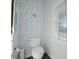Charming powder room with floral wallpaper and natural light at 3075 Maritime Forest Dr, Johns Island, SC 29455