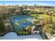 Aerial view of tennis courts in a beautiful community with lush landscaping and a nearby golf course at 3075 Maritime Forest Dr, Johns Island, SC 29455
