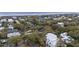 Aerial view of a tree-filled neighborhood featuring well-maintained homes and a glimpse of the ocean at 3304 Hartnett Blvd, Isle of Palms, SC 29451