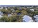 Aerial shot showcases a tree-covered neighborhood, highlighting the proximity to the beach and diverse home styles at 3304 Hartnett Blvd, Isle of Palms, SC 29451