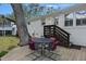 Backyard featuring a cozy wooden deck with dining set, offering a relaxing outdoor space for entertaining and enjoying nature at 3304 Hartnett Blvd, Isle of Palms, SC 29451