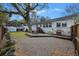 Backyard with patio, grill, and lush green landscaping featuring a beautiful mature tree at 3304 Hartnett Blvd, Isle of Palms, SC 29451