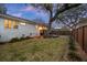 Backyard view showcasing a spacious yard, deck, mature trees, and privacy fence, offering a peaceful outdoor retreat at 3304 Hartnett Blvd, Isle of Palms, SC 29451