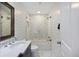 Modern bathroom with white marble, glass shower door, and updated fixtures at 3304 Hartnett Blvd, Isle of Palms, SC 29451