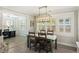 Charming dining room with a stylish light fixture, seating for four, and bright windows at 3304 Hartnett Blvd, Isle of Palms, SC 29451