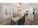 Well-lit dining area with farmhouse table, modern light fixture, and direct access to kitchen at 3304 Hartnett Blvd, Isle of Palms, SC 29451