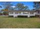 Single-story home with a well-manicured front lawn and tasteful landscaping at 3304 Hartnett Blvd, Isle of Palms, SC 29451