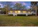 Charming home with white brick exterior, dark shutters, and a well-maintained lawn creating a welcoming curb appeal at 3304 Hartnett Blvd, Isle of Palms, SC 29451