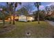 Charming exterior view of a cozy home, surrounded by lush greenery and mature trees, with inviting curb appeal at 3304 Hartnett Blvd, Isle of Palms, SC 29451