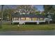 Charming home with white brick exterior, dark shutters, and a well-maintained lawn creating a welcoming curb appeal at 3304 Hartnett Blvd, Isle of Palms, SC 29451
