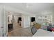 Bright living room with french doors and white brick accent wall at 3304 Hartnett Blvd, Isle of Palms, SC 29451