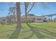 Expansive backyard featuring a brick home, sunny patio, fire pit, and string lights for outdoor entertaining at 3552 Old Ferry Rd, Johns Island, SC 29455