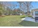 Large backyard featuring a fire pit area, a sunroom, large shade trees and an outbuilding at 3552 Old Ferry Rd, Johns Island, SC 29455