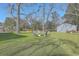 Backyard featuring a fire pit with chairs, large shade trees and an outbuilding at 3552 Old Ferry Rd, Johns Island, SC 29455