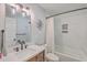 Well-lit bathroom featuring a shower-tub combo, a modern vanity and mirror, and gray and white colored tile at 3552 Old Ferry Rd, Johns Island, SC 29455