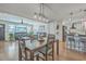 Open concept dining room with modern chandelier, views of living room, kitchen, and front yard at 3552 Old Ferry Rd, Johns Island, SC 29455