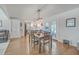 Open concept dining room with a dining table, view to the kitchen, and french doors to the porch at 3552 Old Ferry Rd, Johns Island, SC 29455