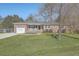 Charming brick home featuring a manicured lawn, attached garage, and welcoming front porch at 3552 Old Ferry Rd, Johns Island, SC 29455