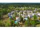 Aerial view of a home in a residential area featuring a private pool and lush surroundings, creating a serene environment at 4029 Cascades Thrust, Summerville, SC 29483