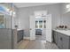 An elegant bathroom featuring double vanities, a walk-in shower, and open doorway to the bedroom at 4029 Cascades Thrust, Summerville, SC 29483